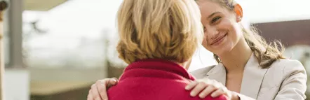 Woman resting her hands on shoulders smiling