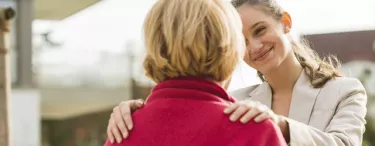 Woman resting her hands on shoulders smiling